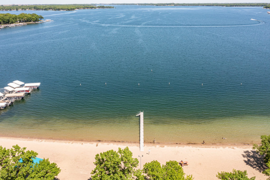 an aerial image of the lake in Homes for Sale in The South End, Okoboji, IA Community Guide Page