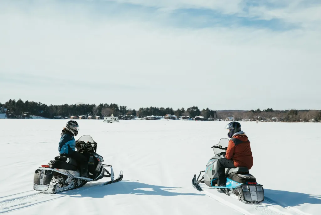people riding snowmobiles, things to do in spirit lake iowa