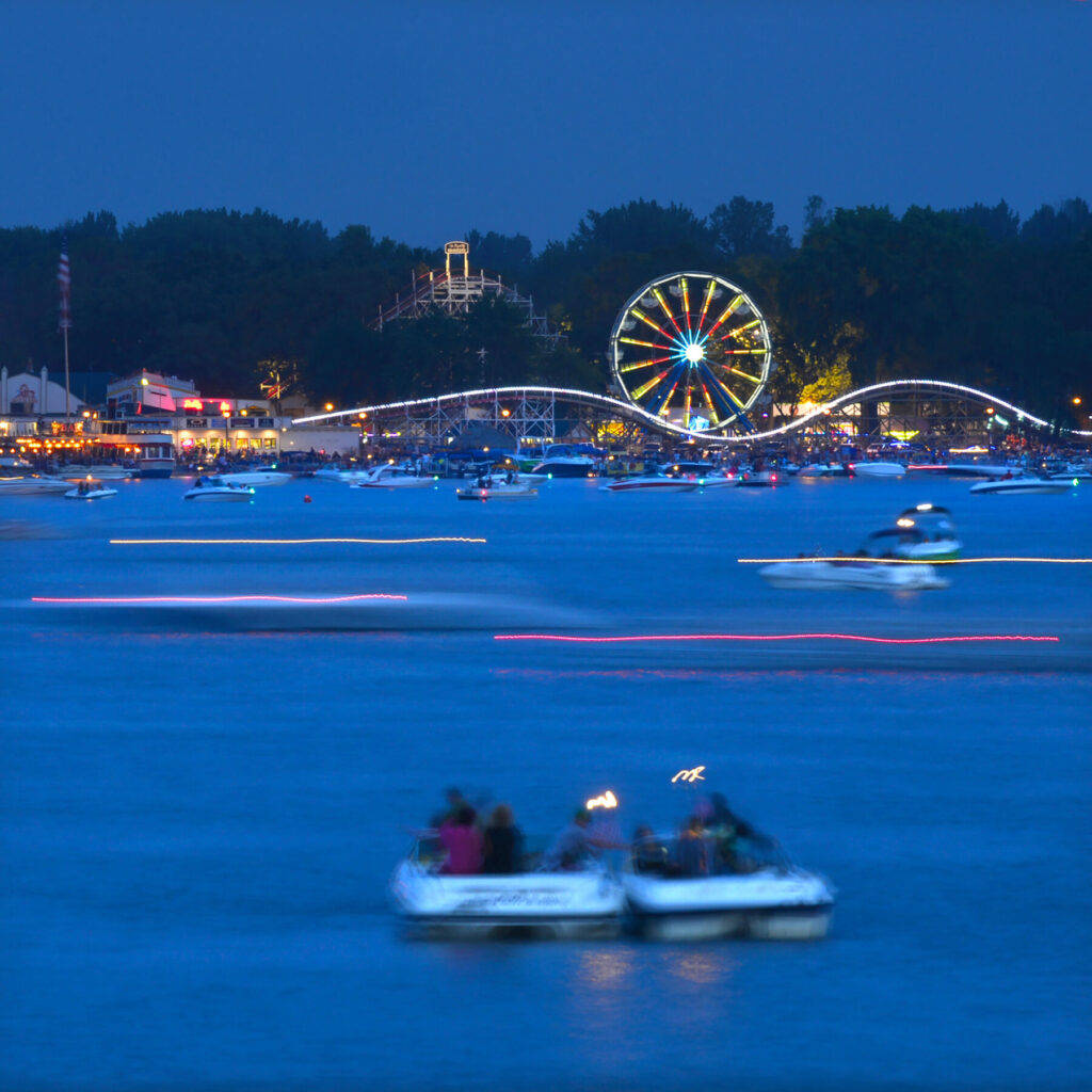 Boaters enjoy a beautiful night by Arnolds Park on West Lake Okoboji.