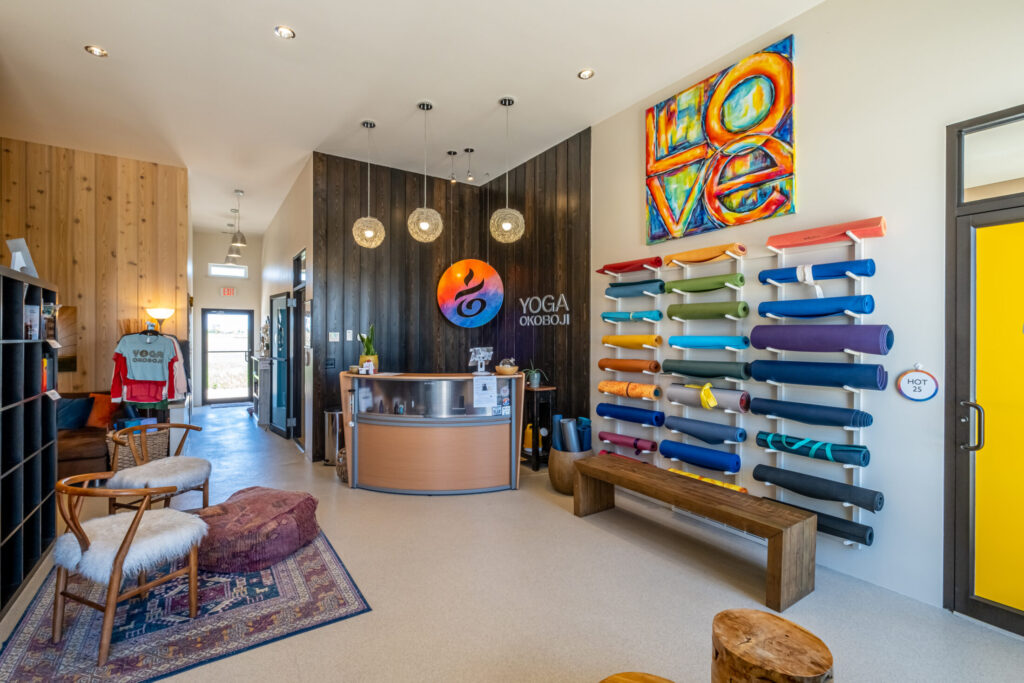 a photo of the front counter and yoga matts on the wall inside the Yoga Okoboji building