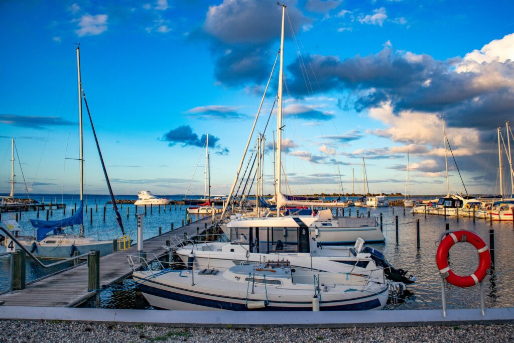 a white boat near the docks during daytime
