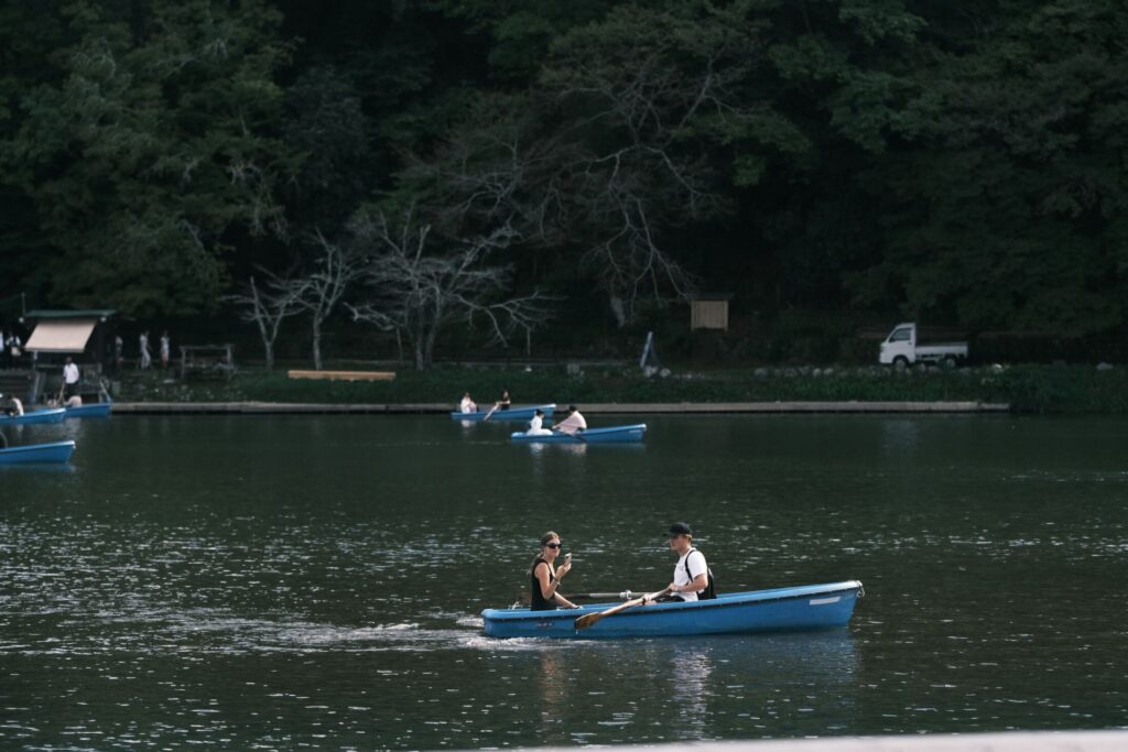 a couple of people in a blue boat on a body of water