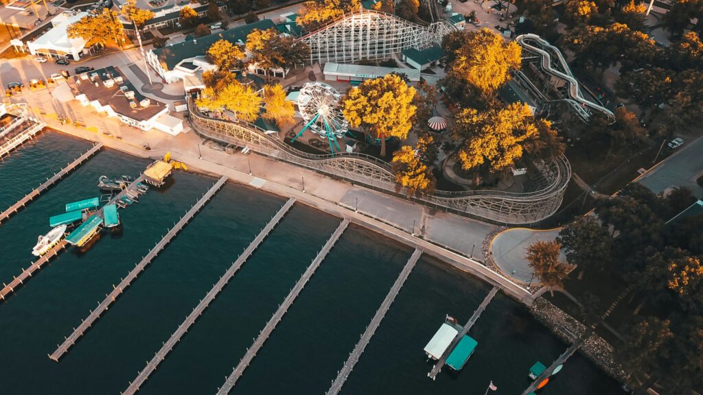 an aerial photo of a lake near a carnival