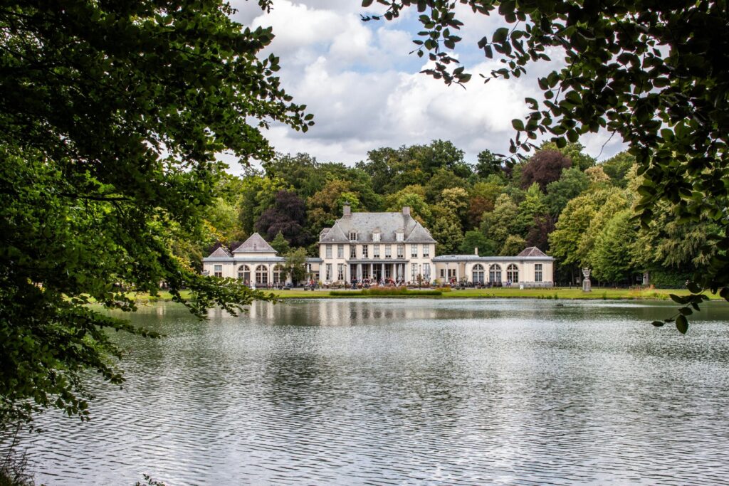 a large white house sitting on top of a lake