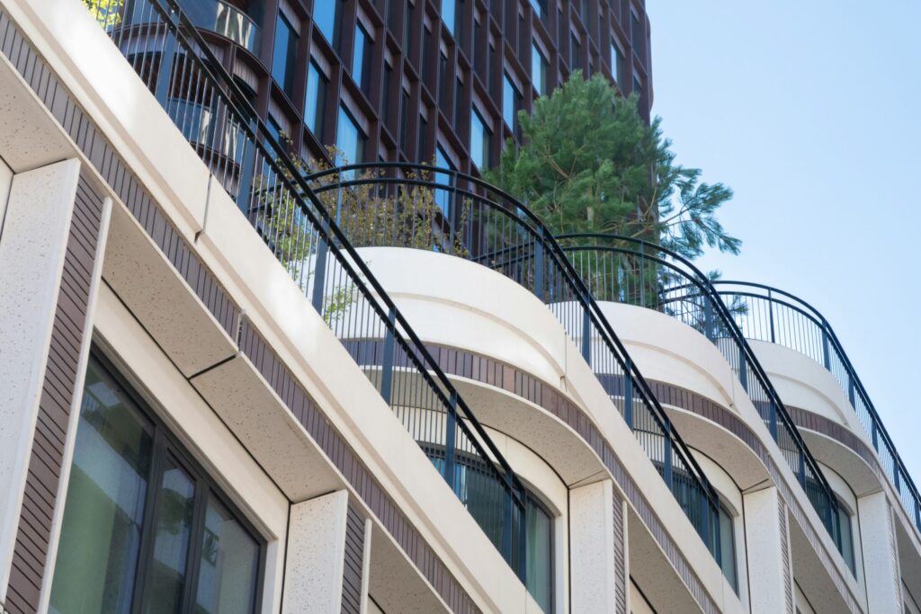 a building with decorative balcony with plants