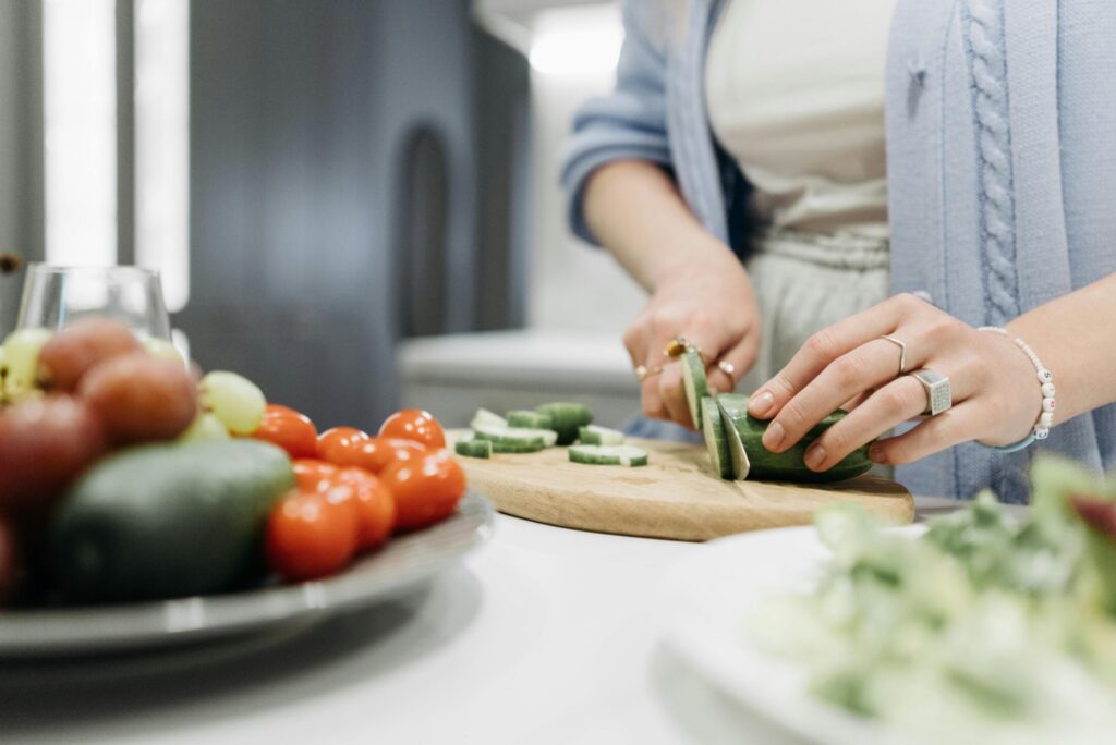 a person slicing a cucumber