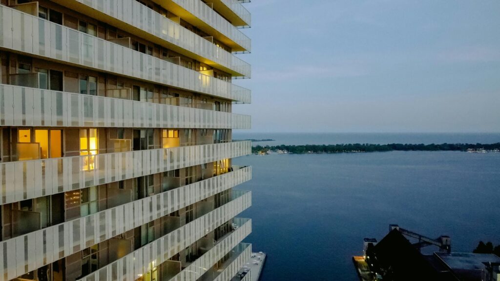 white and brown concrete building near body of water